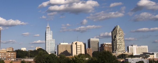 Photo of clouds over the city of Raleigh's sky scrapers.