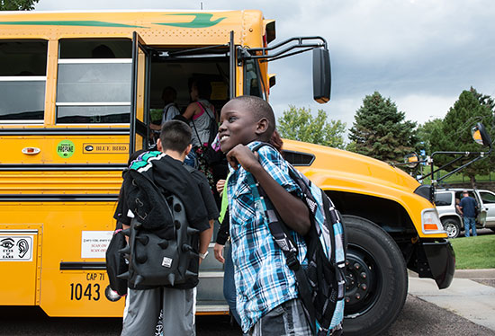 children boarding a school bus