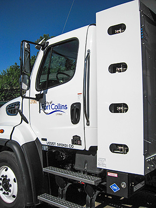 The cab of a heavy-duty dump truck in the Fort Collins fleet. Compressed natural gas fuel cylinders are located behind the cab.