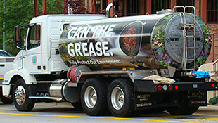 A photo of an old fuel oil delivery truck into a biodiesel-fueled water tanker. The utility has wrapped the truck in messaging that encourages customers to stop disposing of grease down the drain.