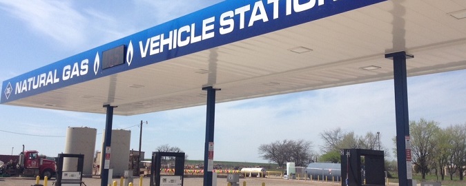 A photo of a fueling station with six pumps.