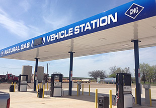 A photo of a fueling station with six pumps.