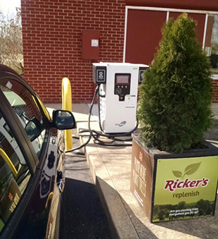 Photo of an PEV plugged in at Ricker's new electric charging station.