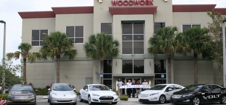Photo of plug-in electric vehicles parked in front of Hollywood Woodwork headquarters