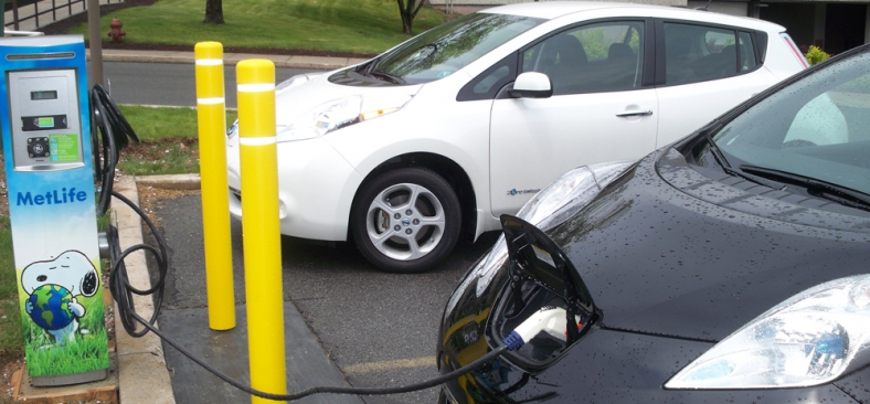 Photo of a plug-in electric vehicle connected to EVSE at a Met Life facility.
